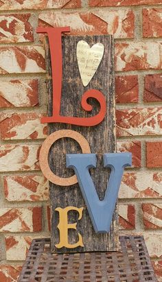 a wooden sign that says love on it