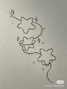 a drawing of stars and swirls on the side of a white paper with black ink