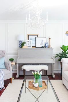 a living room filled with furniture and a piano