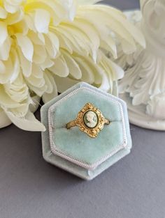 An enchanting cameo ring that features a classic portrait of a Grecian Goddess in a bezel setting. Resembling a kite-shaped shield, the ring face is decorated with ornate milgrain detailing. SIZE: This ring is adjustable, which is convenient if you aren't sure what size your recipient's finger is or if you like wearing rings on different fingers.  In order to resize the ring, simply slide apart the two pieces on the back or underside of the ring and push them together. The smallest I can manage Cameo Ring Gem, Vintage Oval Cabochon Opal Ring Gift, Vintage Cameo Signet Ring, Vintage Cameo Rings For Wedding, Vintage Cameo Signet Ring For Anniversary, Elegant Cameo Signet Ring For Anniversary, Antique Cabochon Emerald Wedding Ring, Victorian Cabochon Wedding Rings, Heirloom Cabochon Emerald Ring For Wedding