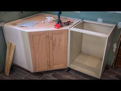 an unfinished kitchen cabinet is being built