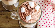 two cups filled with hot chocolate and marshmallows