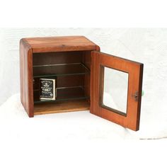 an open wooden box with a mirror inside