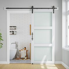 an open door leading to a bathroom with a plant in the corner and other items on the floor