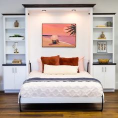 a bed sitting in the middle of a bedroom next to a wall mounted book shelf