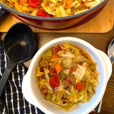 two bowls filled with food sitting on top of a wooden table