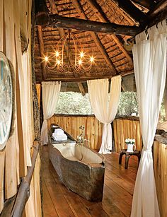 a bathroom with a tub and chandelier in it