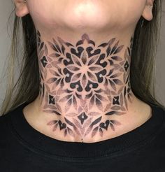 a woman's neck is adorned with intricate designs