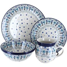 a blue and white dinner set with flowers on it