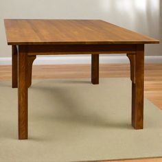 a wooden table sitting on top of a rug