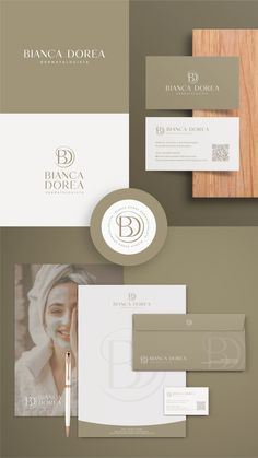 the brand identity and business cards are displayed on top of two different pieces of paper