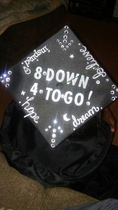 a black graduation cap with the words down 4 to go written in white on it