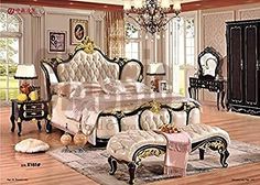 an ornate bedroom with white furniture and chandelier