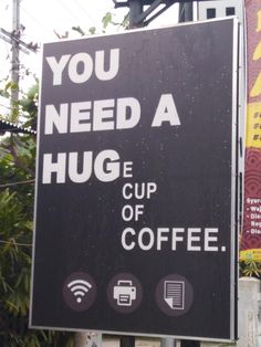 a sign that says you need a hug cup of coffee