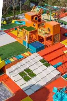 an aerial view of colorful playgrounds and play areas with artificial grass on the ground