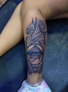 a woman's leg with an all seeing tattoo on it