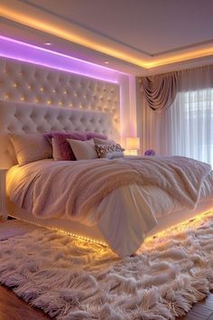 a bedroom with white fur rugs and lights on the wall above the headboard