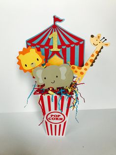 an elephant, giraffe and zebra in a popcorn box