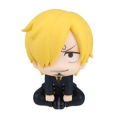 an anime figurine is sitting on the ground with his eyes closed and mouth open