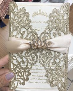 someone holding up a wedding card with a bow on it