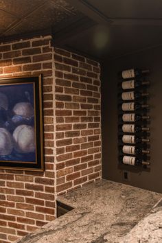 a brick wall in a wine cellar with marble counter tops