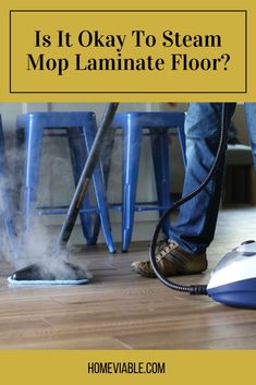 a person using a steam mop on the floor with text overlay that reads is it okay to steam mop laminate floor?