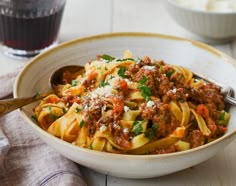 a white bowl filled with pasta and meat sauce