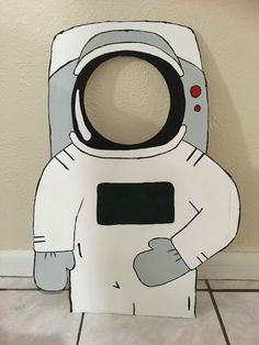 a cardboard cut out of an astronaut standing on the floor