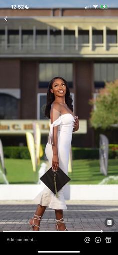 a woman in white dress walking down the street