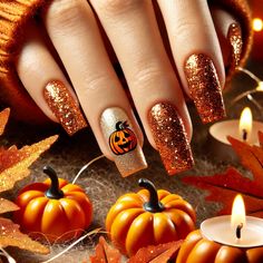 Get the ultimate fall vibes with these orange and gold glitter nails, featuring a tiny pumpkin design. Surrounded by autumn leaves and glowing in soft light, these festive nails capture the cozy essence of Halloween. Add some seasonal warmth to your style with these pumpkin-inspired nail art ideas. Pumpkin Glitter Nails, Halloween Thanksgiving Nails, Holiday Nails Thanksgiving Fall, Glitter Pumpkin Nails, Gold Pumpkin Nails, Glittery Fall Nails, Gold Halloween Nails, Autumn Nails Pumpkin, Halloween Nails Glitter