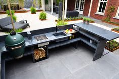 an outdoor bbq with grill and seating area