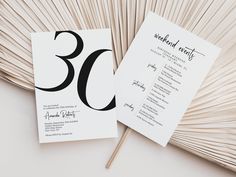 a white and black wedding program with the number 50 on it's back side