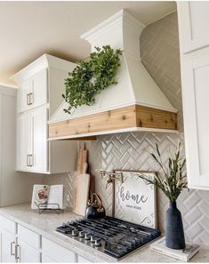 a stove top oven sitting inside of a kitchen next to white cabinets and counter tops