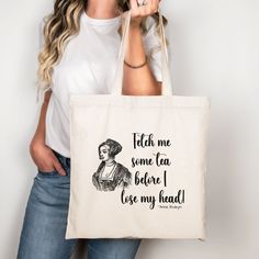 a woman holding a tote bag that says tell me some tea before i use my head