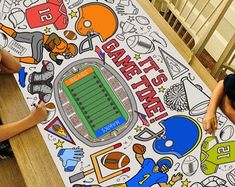 two children sitting at a table with a large poster on it that says football time