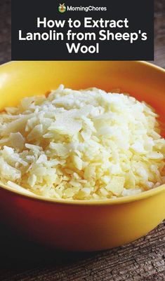 a yellow bowl filled with rice on top of a wooden table