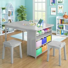 a child's table and chairs in a room with blue walls