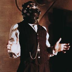 a man wearing a mask and holding his hands out