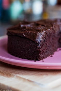 a piece of chocolate cake on a pink plate