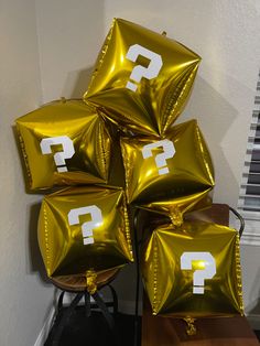 five gold foil bags with question mark on them sitting on top of a wooden table