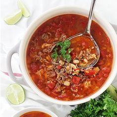 two bowls filled with soup and garnished with cilantro