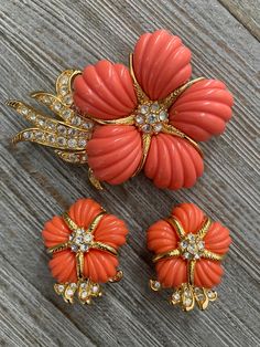 "Stunning Vintage NOLAN MILLER Signed Gold And Orange Floral Statement Brooch And Clip Earrings Set Circa 1990's Excellent condition....like new Signed Nolan Miller Very nice quality and weight Gold finish with coral colored lucite and clear rhinestones Classic and timeless Colorful Floral shaped Statement making pieces 1.8\" high, 2.7\" widebrooch 1.2\" high, 1\" wideClip earrings" Abandoned Garden, Nolan Miller Jewelry, Coral Jewelry Vintage, Statement Brooch, Nolan Miller, Gold And Orange, Miriam Haskell Jewelry, Clip Earring, Coral Jewelry