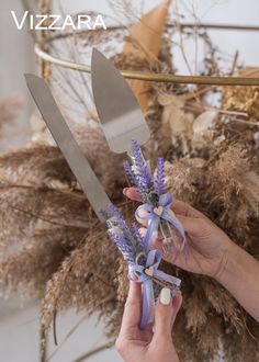 a person holding scissors and flowers in front of some dried plants with the words vizzara on it