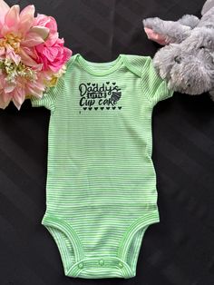 DESCRIPTION: Imagine the laughter that will erupt when your little bundle of joy sports this cute,funny bodysuit. The perfect blend of humour and charm for your little munchkin. This fun and lighthearted design is a celebration of the boundless love and laughter that your little one brings to the whole family. Where cuteness meets cleverness, this one piece is perfect for a gender reveal gift, baby shower gift,  new baby gift, Christmas gift, or as a gift from mom and dad to spice up your little Funny Cotton Onesie For Babies, Playful Cotton Onesie For First Birthday, Cute Green Bodysuit For Playtime, Cute Onesie With Name Print For Playtime, Cute Cotton Onesie For Birthday, Cute Onesie With Letter Print For Playwear, Cotton Cute Onesie For Birthday, Cute Cotton Onesie, Green Short Sleeve Cotton Onesie