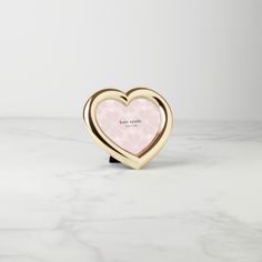 a pink heart shaped object sitting on top of a white counter