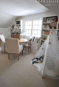 a teepee tent sitting in the middle of a living room