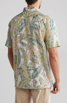 All-cotton construction offers a lightweight and breathable feel in a button-down shirt covered in a tropical print for laid-back vibes. 30 1/4" length Front button closure Button-down collar Short sleeves 100% cotton Machine wash, tumble dry Made in the USA of imported fabric Green Cotton Hawaiian Shirt For Spring, Spring Green Cotton Hawaiian Shirt, Casual Cotton Tops With Palm Tree Print, Casual Cotton Top With Palm Tree Print, Green Cotton Beach Shirt, Summer Leaf Print Relaxed Fit Tops, Relaxed Fit Leaf Print Summer Top, Relaxed Fit Leaf Print Top For Summer, Casual Green Shirt With All Over Print