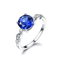 a blue sapphire and diamond ring on a white background