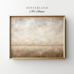 an abstract painting hangs on the wall above it is a gold frame that reads hintterland after shoppe