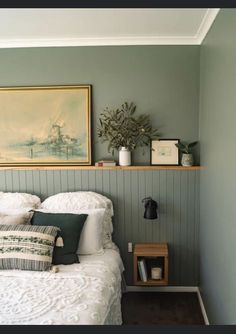 a bedroom with green walls and white bedding